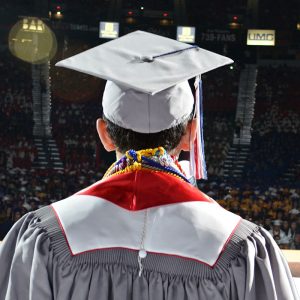 A graduate speaking in front of his class