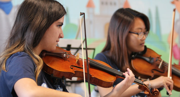 Centennial HS orchestra students perform at Divich ES' dedication ceremony