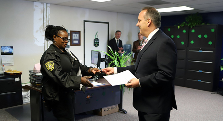 Superintendent Jara distributes the first set of his coins