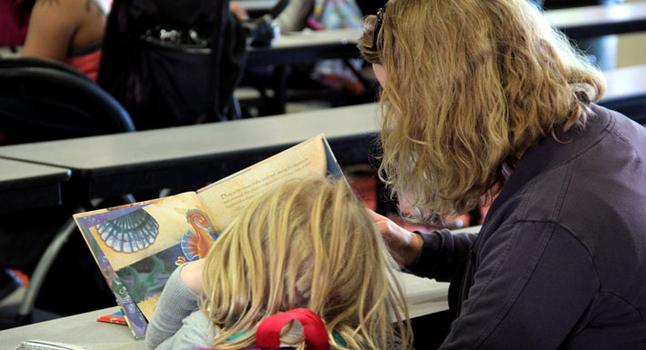 A parent reads with her child during a Books 4 Breakfast at McCaw STEAM Academy