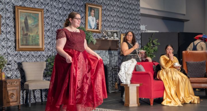 Students perform on stage for a school production.