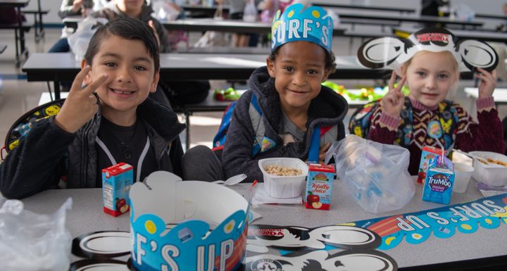 Students pose for a photo during school breakfast.