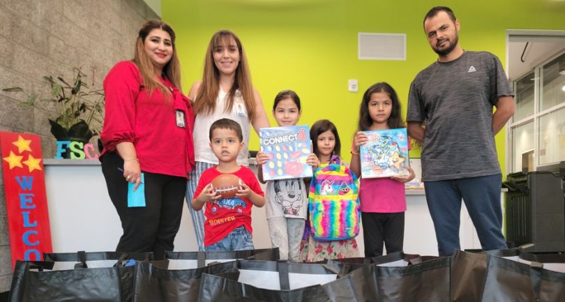 A family poses for a photo after being welcomed by the CCSD Family Support Center.