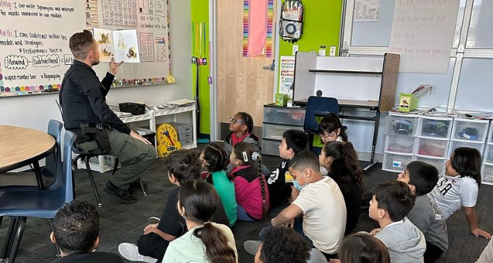 A Las Vegas Metropolitan Police Department officer reads to students during Nevada Reading Week.