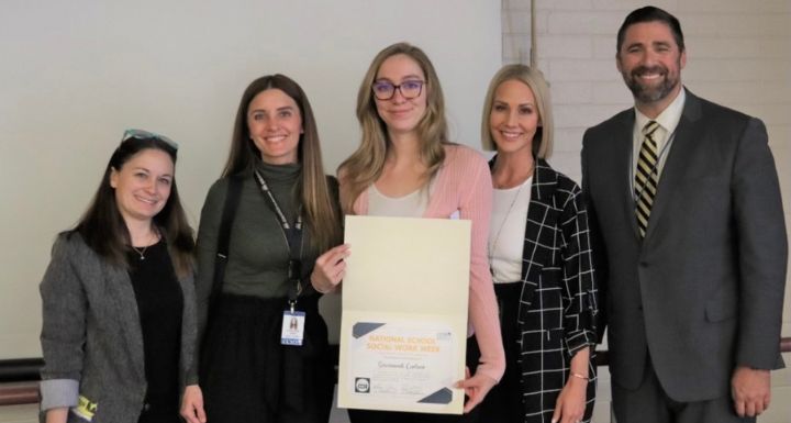 CCSD school social workers pose while holding a certificate.