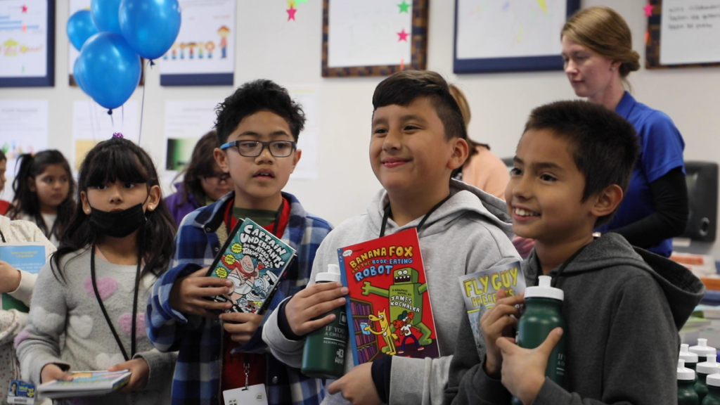 Students at reading event with books