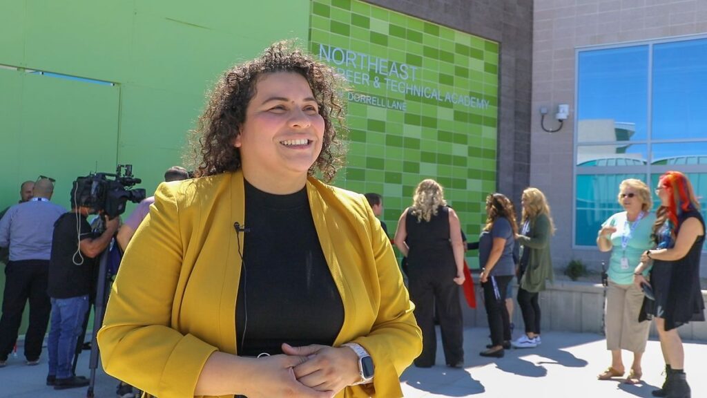 School Board President Evelyn Garcia Morales is interviewed outside Northeast Career and Technical Academy at the start of this academic year.