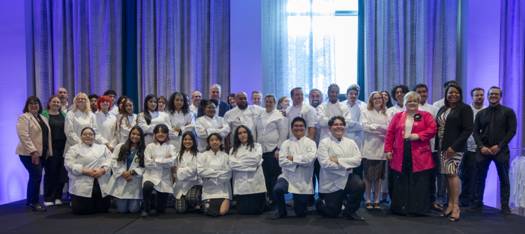 Students from CCSD’s Culinary Program in their chef jackets after accepting jobs with MGM