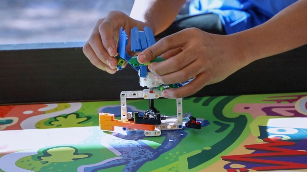 Student's hands working with robotics