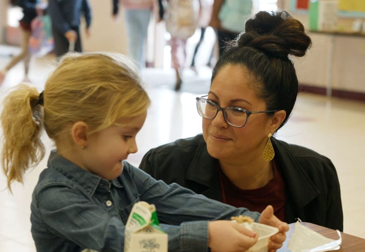 Principal and student in an elementary school cafeteria