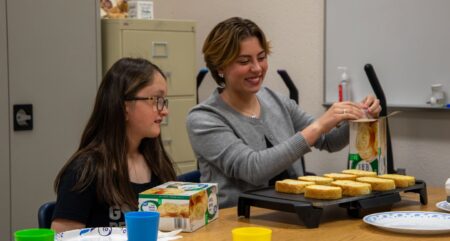 Foothill High School students in the Best Buddies program, Adison Branscum and Sydney Lovio, prepare garlic toast to go with pasta during a recent cooking lesson.