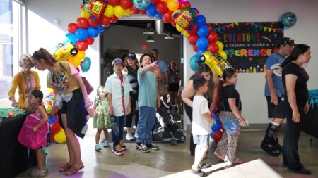 Students attend a backpack giveaway at the Richard Harris Law Firm.